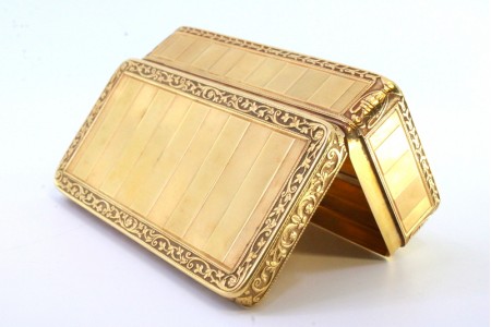 Caixa de rapé em ouro com bandas relevadas ao alto, envolvidas por friso 